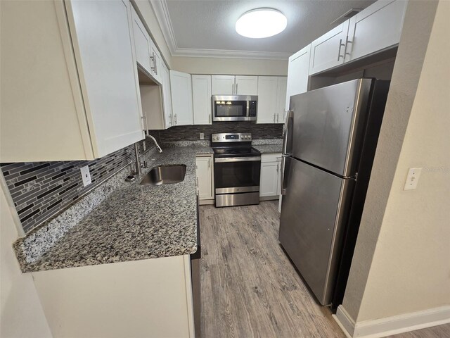 kitchen featuring light hardwood / wood-style flooring, stainless steel appliances, sink, and white cabinetry