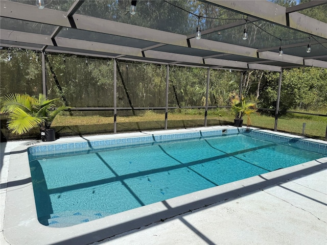 view of pool with glass enclosure