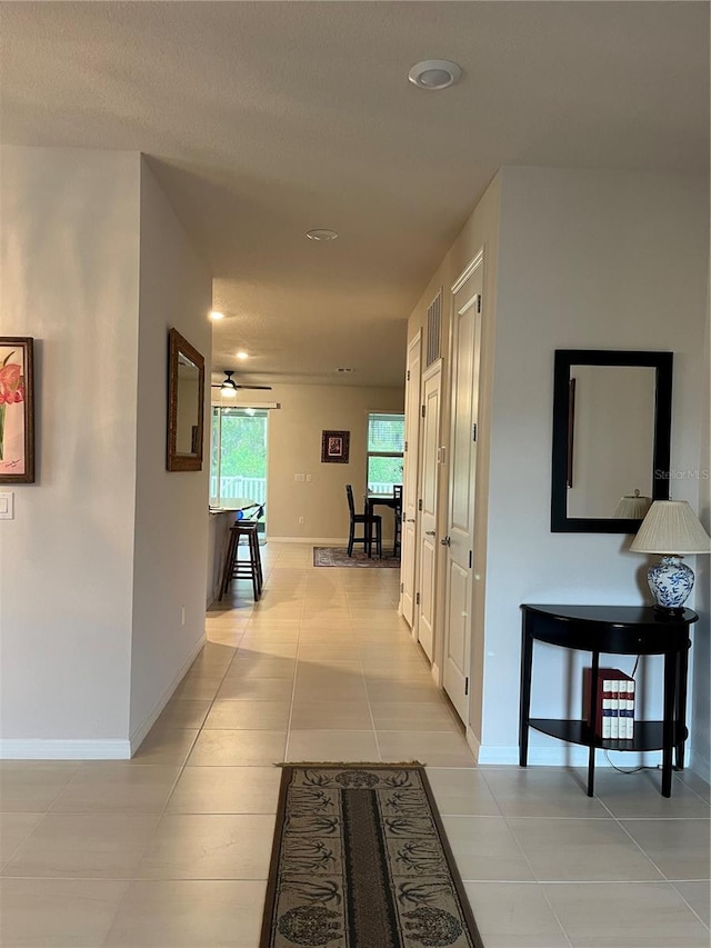 hallway with light tile patterned floors