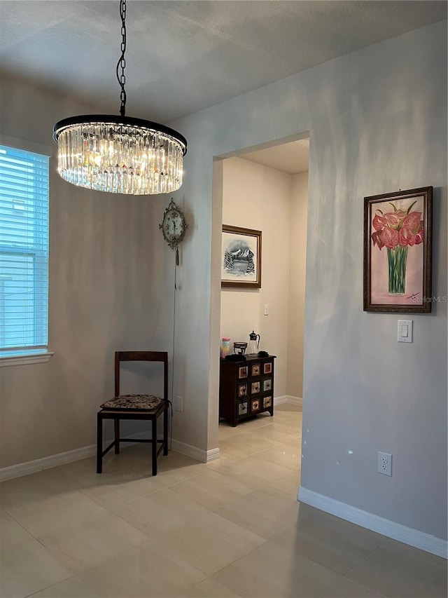 hall with an inviting chandelier