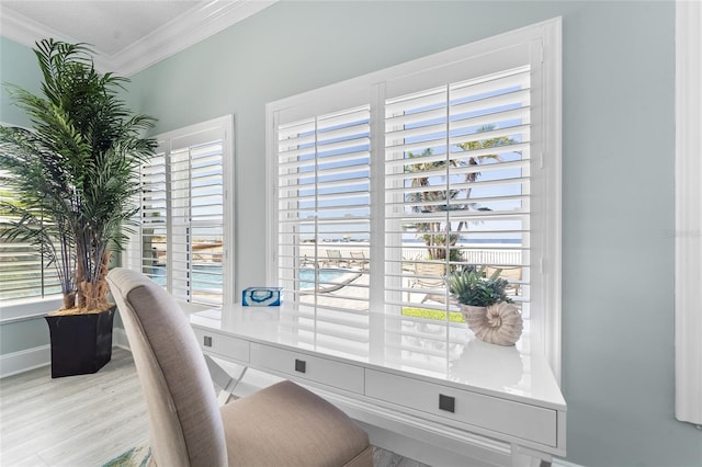 home office with light hardwood / wood-style floors and crown molding