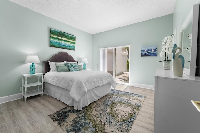 bedroom with hardwood / wood-style flooring and a textured ceiling