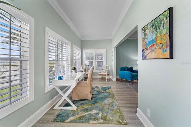 office area with a wealth of natural light, ornamental molding, and hardwood / wood-style flooring