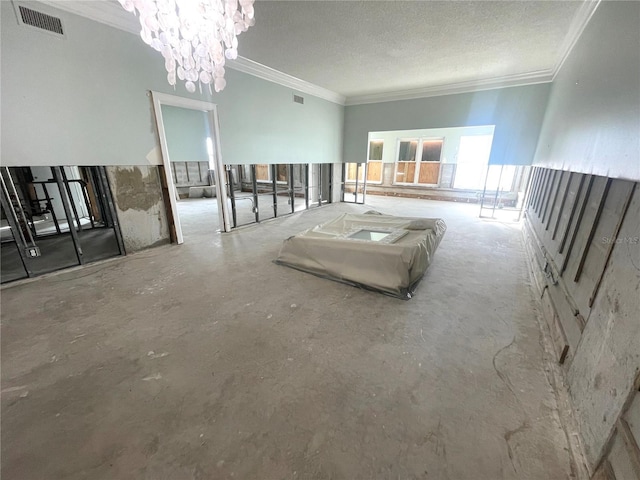 interior space with a chandelier, visible vents, a textured ceiling, and crown molding