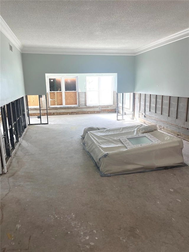 unfurnished bedroom with crown molding, visible vents, and a textured ceiling