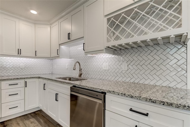 kitchen with white cabinets, backsplash, sink, dark hardwood / wood-style floors, and stainless steel dishwasher