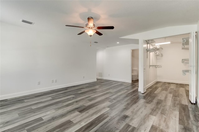 911 8th Ave SW, Largo, FL 33770 - unfurnished room featuring wood finished floors, visible vents, baseboards, and ceiling fan