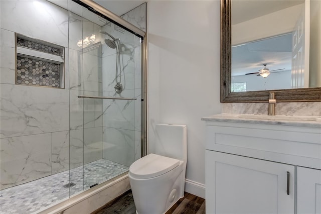 911 8th Ave SW, Largo, FL 33770 - full bath with wood finished floors, toilet, vanity, a marble finish shower, and ceiling fan