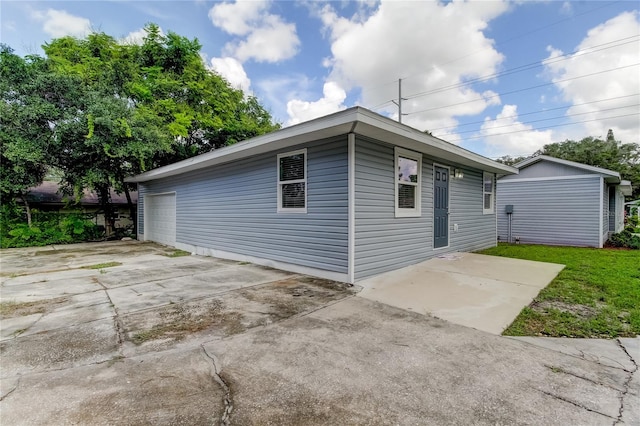 view of side of home featuring a yard and a patio area