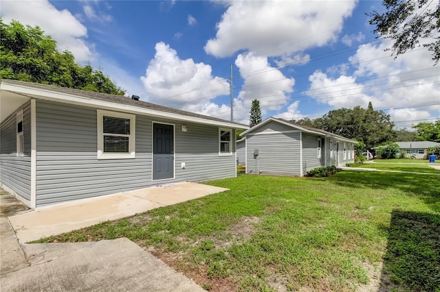 911 8th Ave SW, Largo, FL 33770 - rear view of house with a yard and a patio