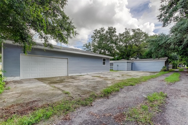 view of side of property with an outdoor structure and a garage