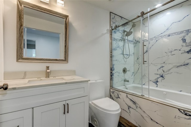 full bathroom with shower / bath combination with glass door, toilet, and vanity