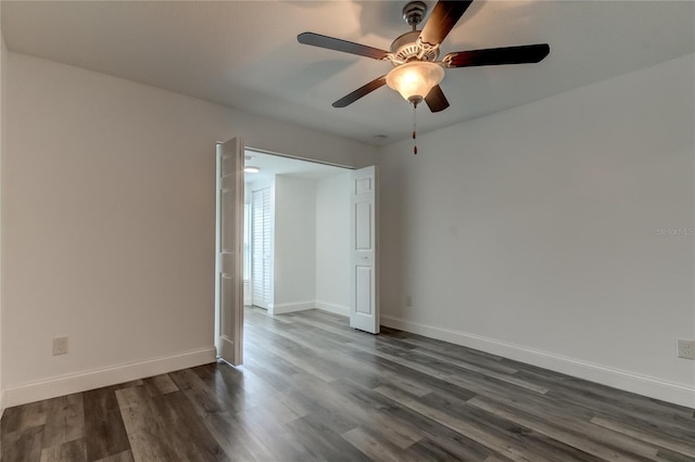 spare room with ceiling fan and dark hardwood / wood-style flooring