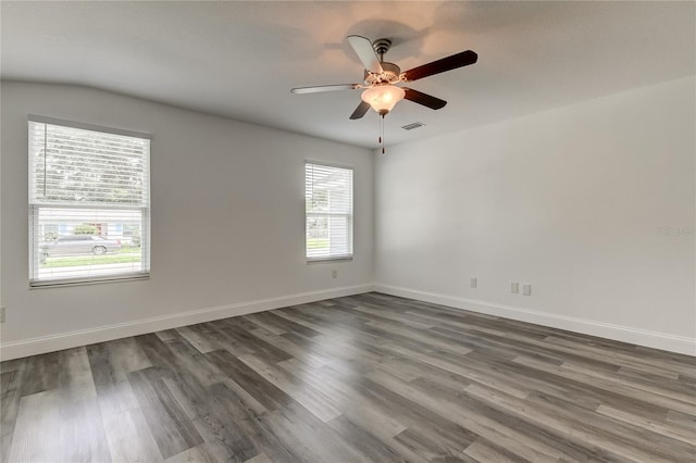 spare room featuring ceiling fan and dark hardwood / wood-style floors