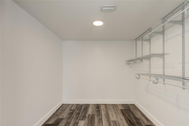 spacious closet with dark hardwood / wood-style floors