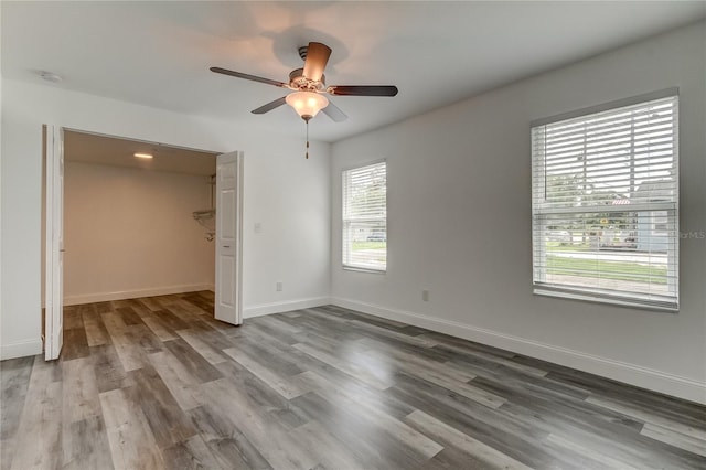 interior space with wood-type flooring and ceiling fan