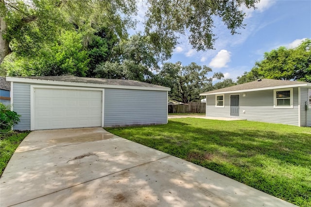 view of yard featuring a garage and an outbuilding