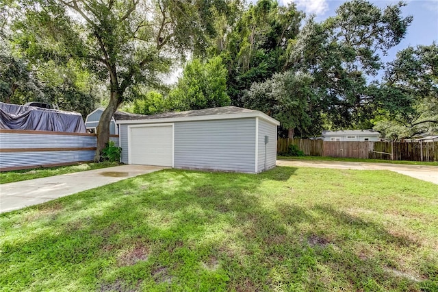 view of yard featuring an outbuilding and a garage