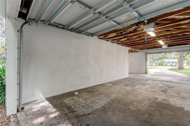 911 8th Ave SW, Largo, FL 33770 - garage with a garage door opener and baseboards