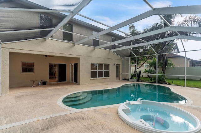 view of swimming pool with a lanai, an in ground hot tub, and a patio area