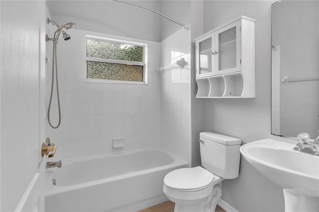 full bathroom with toilet, tiled shower / bath combo, and sink