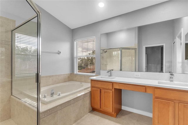 bathroom featuring tile patterned flooring, shower with separate bathtub, and vanity