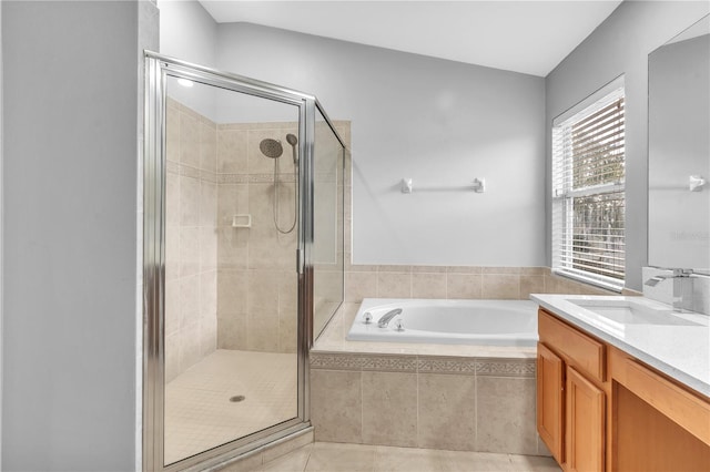 bathroom featuring tile patterned flooring, vanity, and separate shower and tub