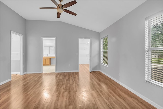 unfurnished living room with light wood-type flooring, ceiling fan, and a wealth of natural light