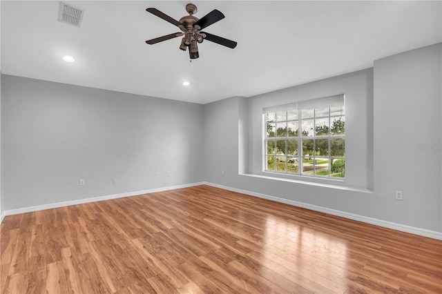 unfurnished room with ceiling fan and light hardwood / wood-style floors