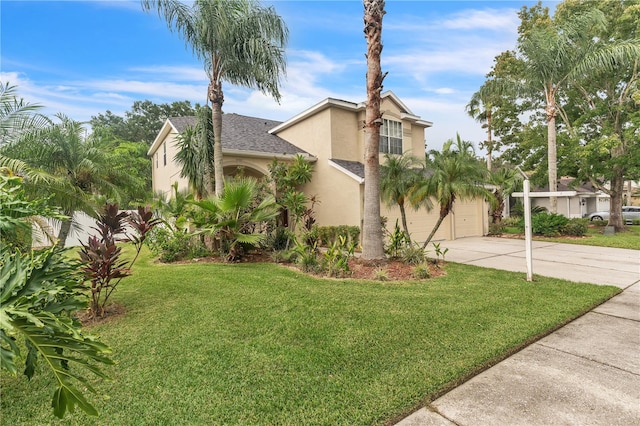 view of front of property with a garage and a front lawn