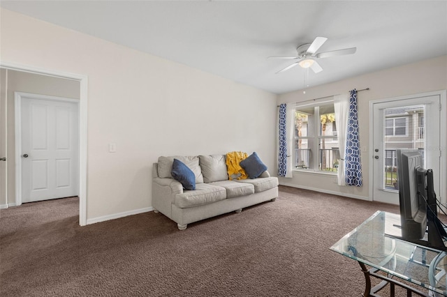 living room with ceiling fan and carpet flooring