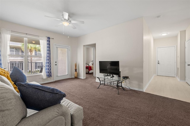 carpeted living room featuring ceiling fan