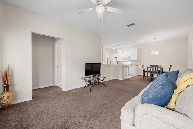 living room featuring carpet flooring and ceiling fan