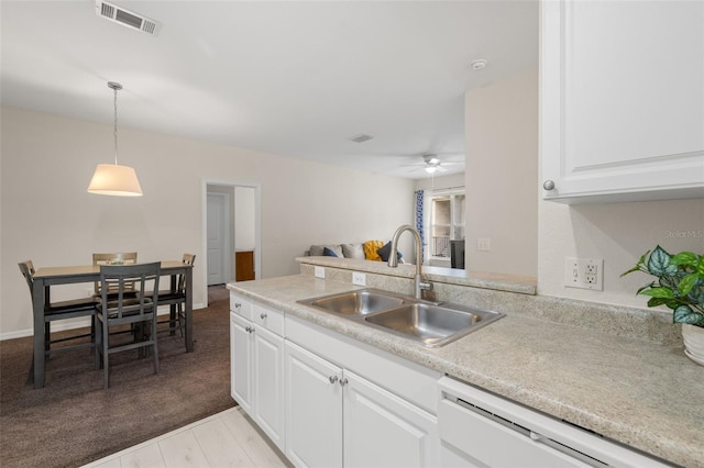 kitchen with dishwasher, sink, white cabinets, hanging light fixtures, and ceiling fan