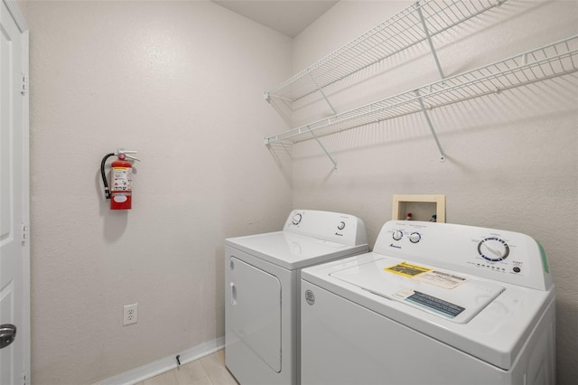 washroom featuring light hardwood / wood-style floors and washing machine and clothes dryer