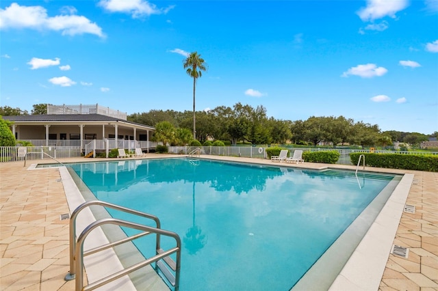 view of swimming pool with a patio