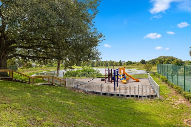 view of playground featuring a water view and a yard