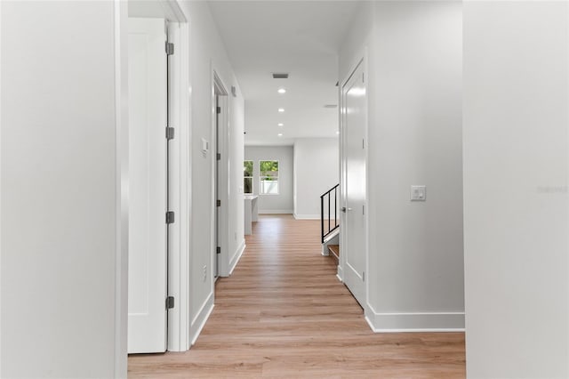 corridor with light hardwood / wood-style floors