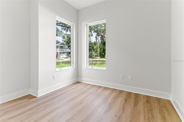 spare room featuring light hardwood / wood-style flooring and a wealth of natural light