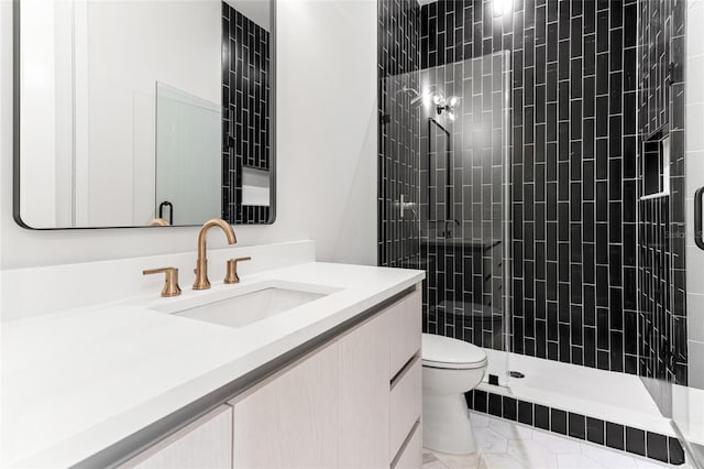 bathroom with tiled shower, tile patterned flooring, vanity, and toilet