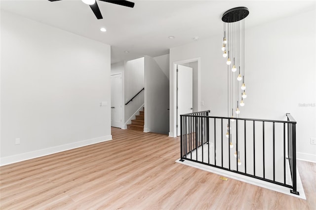 unfurnished room featuring ceiling fan and light hardwood / wood-style flooring