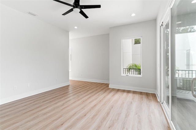 empty room with ceiling fan and light hardwood / wood-style floors