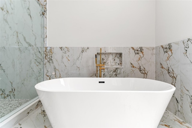 bathroom featuring tile walls and a tub