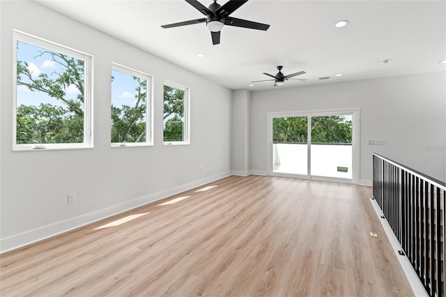 unfurnished room featuring ceiling fan, light hardwood / wood-style flooring, and plenty of natural light