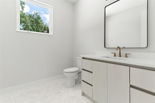 bathroom with toilet, tile patterned floors, and vanity