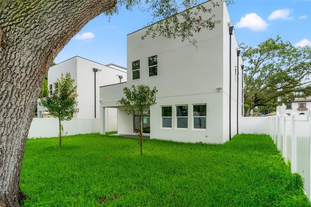 back of house with a yard