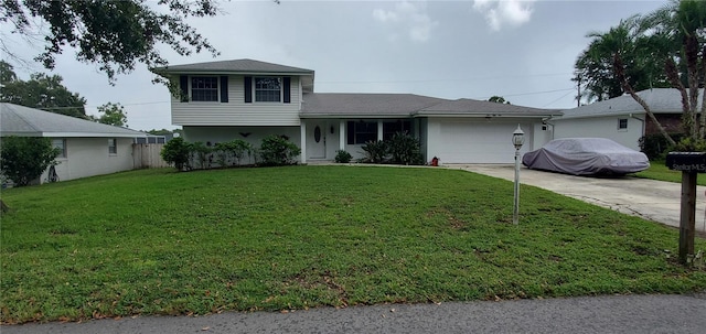 tri-level home featuring a front yard and a garage