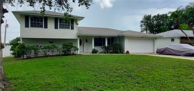 view of front of home with a garage and a front lawn