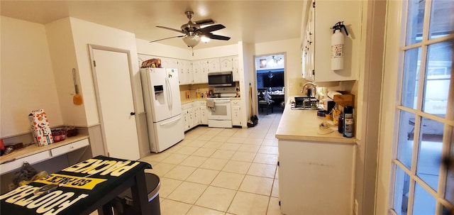 kitchen with white cabinets, white appliances, light tile patterned flooring, and ceiling fan