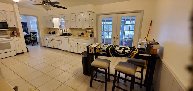 kitchen featuring white cabinets, white appliances, light tile patterned flooring, and ceiling fan